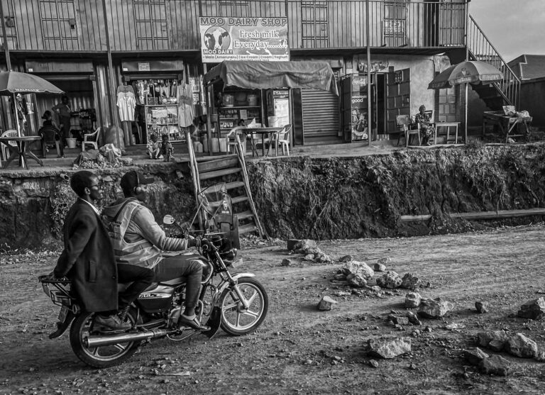 Theme: Street Photography, February 2024 – first place: Rich Shore, “Rough Road Ahead”